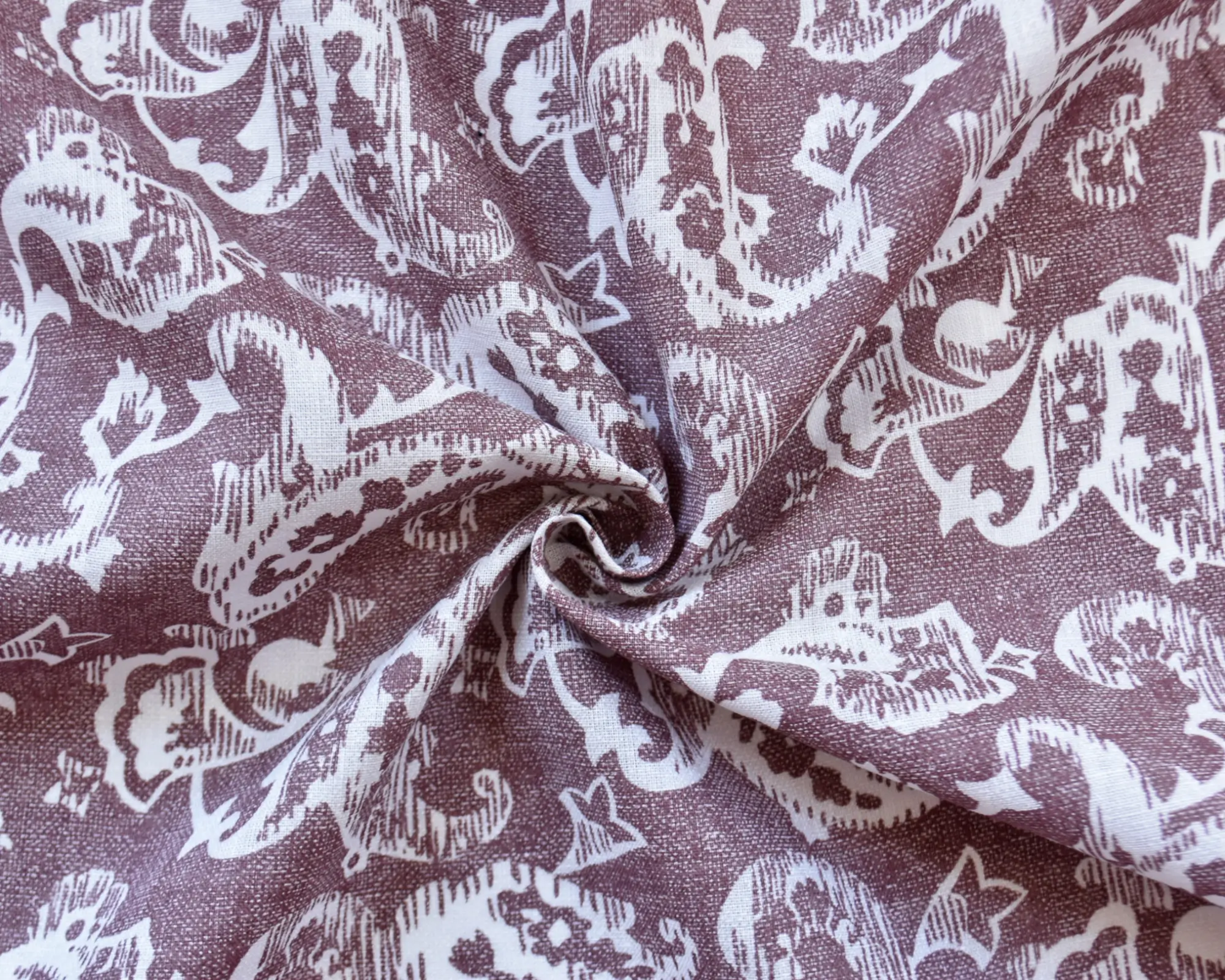 Linen cotton blend mauve fabric with white paisley motifs