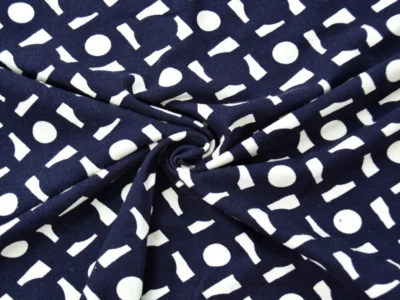 Rayon spandex jersey by the yard with a navy blue background and white geometric shapes